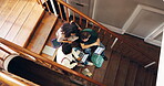 People, stairs and university students with technology for study, group assignment, or research. Above, man and women at college with laptop, tablet and books for discussion, thesis or education