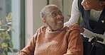 Wheelchair, nurse and checkup with old woman, support and talking for assisted living in house. Smile, caregiver and black person with disability, medical help and retirement healthcare in homecare