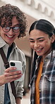 University students, laughing and friends with phone, outdoor and reading post on social media app. College, education and happy people with mobile on campus, talking and funny message on website
