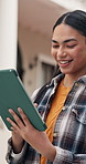 Happy, student and woman at university with tablet, reading and download AI for learning assistance. Outdoor, person and scroll at college with tech, higher education or browse internet for knowledge