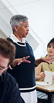 Lecturer, woman and students in class for lesson, exam preparation or support with learning tips. Walk, mature professor or teaching at university for course insight, explain essay topic or education