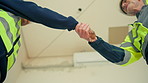 Architect, people and handshake with trust in construction site for building agreement or deal. Low angle, contractor or civil engineer shaking hands with greeting or introduction for partnership