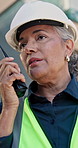 Architect, woman and talking with radio on construction site for building safety or security. Female person, instructor or civil engineer speaking with signal for property inspection or control