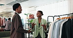 Fashion, choice and stylist with smile in boutique, shopping and consultation for outfit selection. Happy people, discussion and assistance for client, help and advice for clothing decision in store