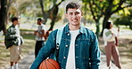 Face, park and happy man with basketball for academic learning journey, travel or outdoor commute. Portrait, male person or exchange student with smile for growth, development or foreign scholarship