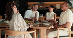 Happy, talking and friends in home for dinner party, celebration and social gathering on weekend. House, hosting and people with conversation, reunion and meal for bonding, connection and visit