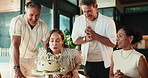 Happy, friends and woman with birthday cake in home for celebration, party and milestone together. Applause, cheer and mature men and women with candles, dessert and gathering for special day
