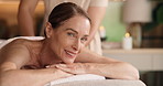 Resort, face and woman on table, back massage and stress relief for muscle tension and hospitality. Spa, luxury and happy mature person on holiday, comfortable and thinking with smile on bed or break