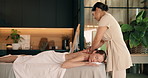 Relax, spa and woman on bed for back massage, holistic treatment and pamper at luxury resort. Hospitality, wellbeing and person with masseuse for healing, stress relief and wellness for salon service