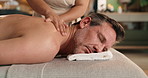 Relax, spa and mature man for back massage, holistic treatment and aromatherapy at resort. Hospitality, rest and person with masseuse for healing, stress relief and essential oil for salon service