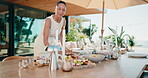 House, food and host outdoor for table setup with charcuterie board, snacks and prepare for event. Mature woman, healthy diet and happy on patio for gathering, party or catering in home backyard