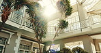 Empty, building and hotel with sunshine for luxury holiday, getaway and vacation for weekend. Hospitality, background and resort with plants, flare and interior design for accommodation and travel