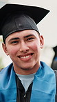 Student, graduation and face with happy man in university ceremony for academic success on campus. Portrait, male person or graduate with smile or hat for education, milestone or learning achievement
