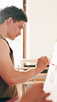 Creative, man and painting in class with canvas, design project and learning for skill development. Artist, person and painter workshop in studio with people, diy hobby and brush for art creation.