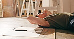 Man, artist and sketch with rest in studio, tired and break from creative technique and workflow. Person, drawing and relax from fatigue, lying down or pause design process for creativity and artwork