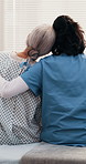 Happy, nurse and old woman in hospital with embrace, discussion and assurance for disease recovery. Healthcare worker, senior person and hug in medical clinic with smile, help and support from back.