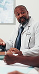 Man, doctor or team with laptop in meeting for speech, presentation or staff training in office. Male person, healthcare worker or speaker with computer for group discussion or medical research