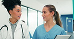 Medical team, doctor and nurse talking in hospital, treatment plan review or schedule coordination. Happy women, healthcare professional and collaboration with document, walking or tablet for results