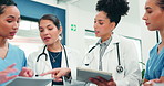 Tablet, discussion and medical team with clinic document,  review records or case report evaluation. Women, doctor and nurses in collaboration with tech, healthcare planning or paperwork feedback