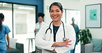 Doctor, face or happy woman with confidence in hospital for medical profession, help or assistance. Portrait, female person or smile with arms crossed for healthcare advice or treatment in clinic