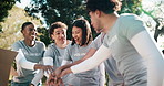 Volunteer, hands together and excited in park for charity, NGO collaboration and applause for goal. People, happy and outdoor with huddle for community service, teamwork and motivation for outreach