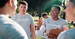Team, leader and volunteer outdoor with meeting, charity briefing or task delegation with smile. People, motivation and clipboard with schedule or agenda for humanitarian aid or community outreach