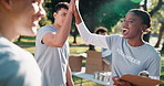 Volunteer, high five or team in park for planning, food distribution schedule or charity goal. People, excited and outdoor with talking for community service, outreach program and donation list