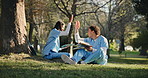 Nurse, education and high five with tablet, outdoor and happy friends with achievement and studying. Park, medical students and excited people with books, talk and celebration for research on web