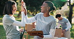 Volunteer, high five or team with clipboard for planning, food distribution schedule or charity goal. Women, excited and outdoor with talking for community service, outreach program and donation list