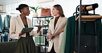 Fashion, team and women in clothing store with tablet, inventory management and retail catalog. Tech, collaboration and people in boutique shop for fabric quality, stock check or merchandising rack