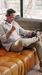 Laptop, remote work and man with win in home office for reward, financial bonus or target on sofa. Computer, mature freelancer and excited person with success, investment growth or fist pump for news