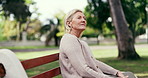 Reflection, breathe and senior woman on bench for thinking, inspiration and relax outdoor. Retirement, happy and elderly person with thought, daydreaming and fresh air for wellness, calm and peace