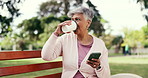 Bench, coffee and senior woman with phone for connection, social media and networking on weekend. Drink, outdoor and person on cellphone for website, contact and text on break, rest and relax in park