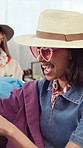 Happy, woman and shopping at store for clothes, choice and clearance sale for thrift fashion. Excited, female person and customer in boutique, vintage outfit and bargain price of designer collection