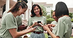 Volunteer, laughing and people with phone, outdoor and social responsibility for community service. NGO, friends and happy team with mobile, humor and reading funny post on web or bonding on break