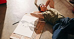 Drawing, artist and relax with man in workshop for illustration, sketching and creative hobby. Easel, art and character design project with above of person in studio for concept commission and vision