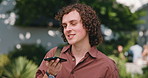 Boy, student or discussion with speaker phone on campus for voice note, sound app or connection. Male person, academic learner or talking with technology or loudspeaker for network or audio message