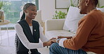 Talking, nurse and senior woman holding hands in home for comfort, bonding and understanding. Retirement, happy and caregiver with African patient for elderly care, medical support and consulting