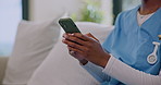 Nurse, hands and typing on sofa with phone, browsing and email response for telehealth notification. Caregiver, woman and online in nursing home with tech, mobile app or website for medical research.