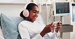 Headphones, phone and child in hospital bed with videos, online movies and internet in clinic. Happy, healthcare and girl on cellphone for streaming, website and distraction for surgery recovery