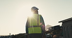 Thinking, helmet and back of construction worker on site for inspection of building, repairs or renovation. Hardhat, man and civil engineer planning for property development or remodeling by flare.