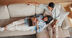 Couple, chilling and bonding with laptop in lounge, point and streaming video with partner in house. Relax, above and happy people with tech on couch, talking and watching movie with spouse in home