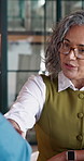 Interview, woman and smile with handshake in office for promotion, internal vacancy or welcome. Notebook, mature HR manager or candidate shaking hands for performance review, contract or hiring