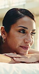 Happy, woman and relax on massage table for spa pamper, muscle therapy and hospitality reflection. Smile, mature client or thinking at wellness resort for body care, unwind or post holistic treatment