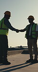 Construction worker, handshake and men with smile, outdoor and agreement for renovation on rooftop. Builder, shaking hands and happy people with achievement, talk and collaboration on building site