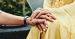 Couple, relax and holding hands outdoor at resort with vacation, love and bonding together on trip. Married people, chill and date at luxury hotel with romantic getaway, care and travel for holiday.