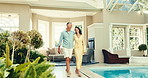 Happy, couple and walking with love in resort for holiday getaway, vacation or honeymoon trip. Man, woman or bonding with pool for travel, accommodation or romantic date together in luxury retreat