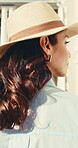 Travel, back or woman with walk for hotel arrival, weekend trip or overnight stay at destination. Hat, female guest or outdoor entrance to accommodation for solo vacation, holiday getaway or check in