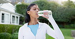 Break, drinking water and fitness with woman in neighborhood for commitment or dedication to cardio. Exercise, hydration and training with runner outdoor in residential community for health workout