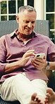 Phone, vacation or man by pool to relax, reading travel blog or text message on social media. Mobile, summer holiday and happy mature person on chair for break, scroll notification or communication